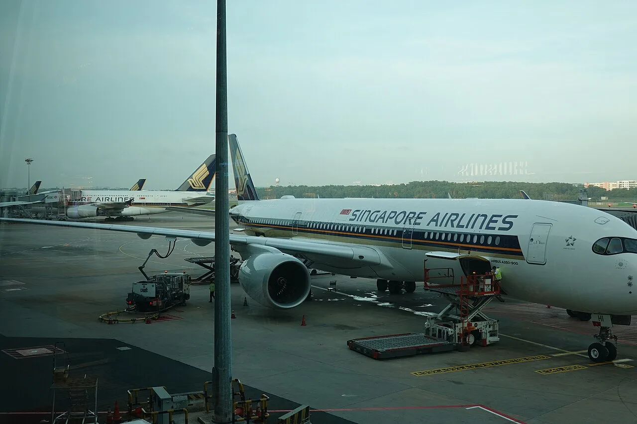 Airline departure boards at a major hub — compare direct and metasearch fares before booking.