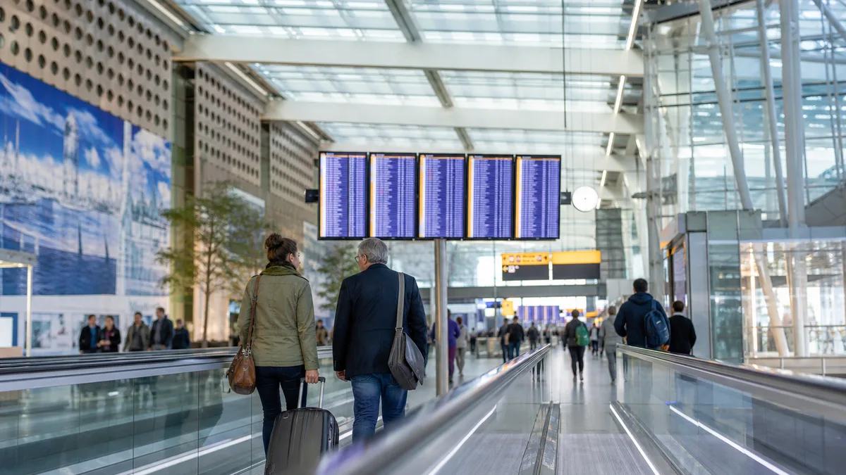 Modern glass airport interior with moving walkway — flying via Amsterdam Schiphol guide (AI-generated illustration)