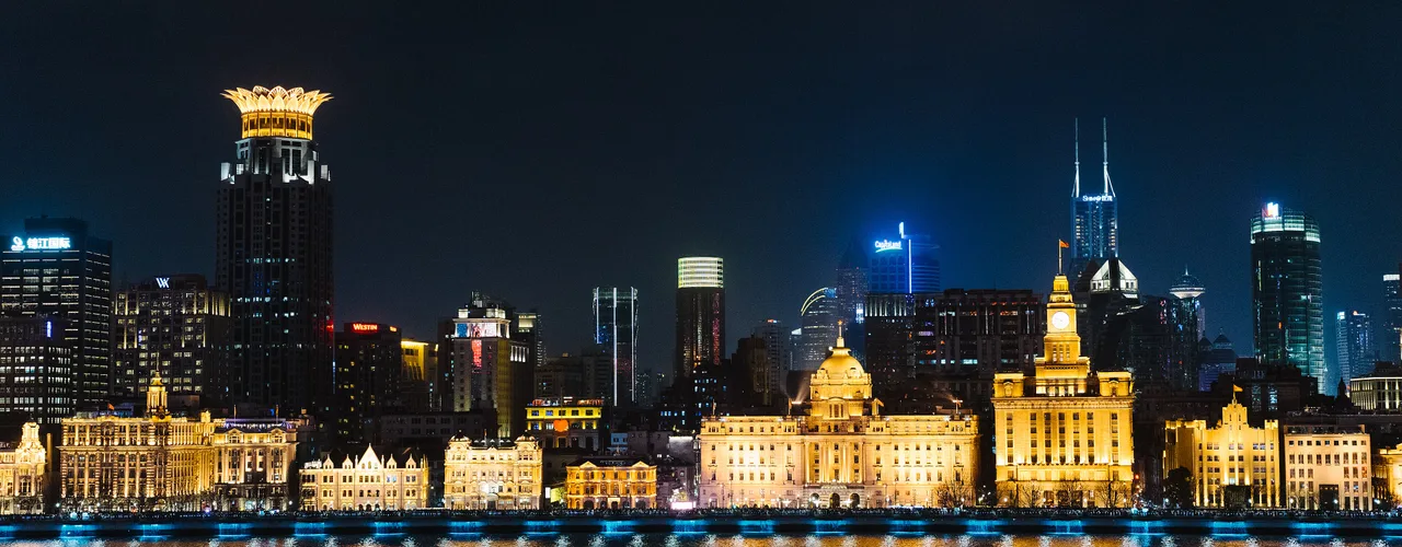 The Bund waterfront in Shanghai lit at night, facing the Pudong skyline