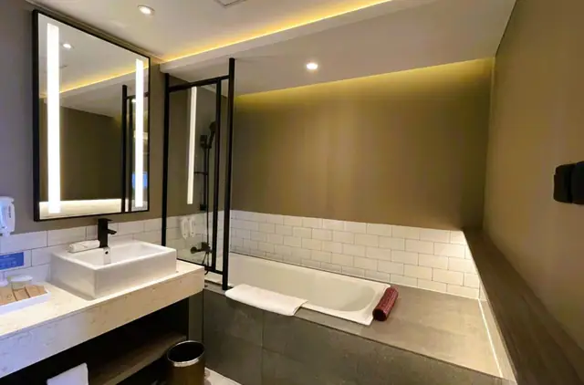 Backlit mirror and twin basins in a Citadines Connect Airport Jakarta bathroom