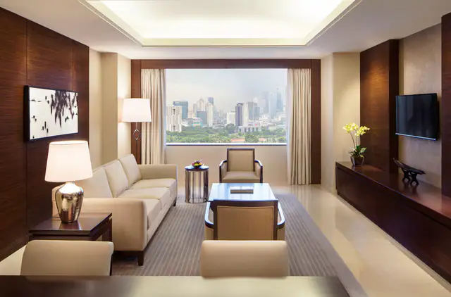 Suite living room with lounge seating at Fairmont Jakarta