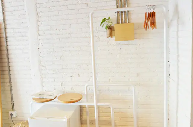 Whitewashed guest room with hanging chair at Greenhost Boutique Hotel Yogyakarta
