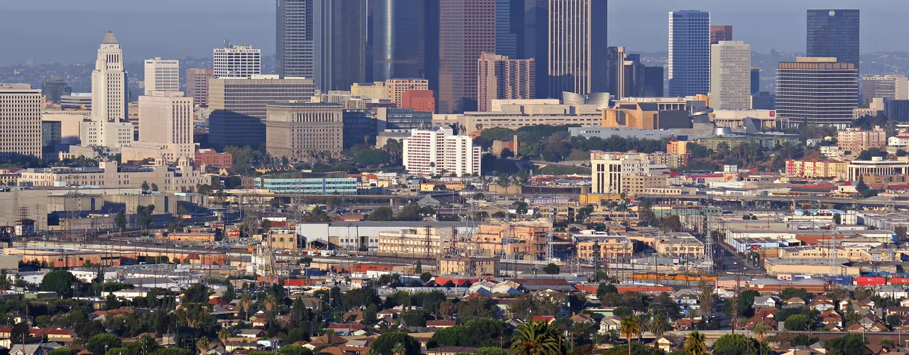 Downtown Los Angeles skyline with towers rising under a clear sky