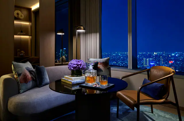 Suite lounge at Pan Pacific Jakarta with night-time city views