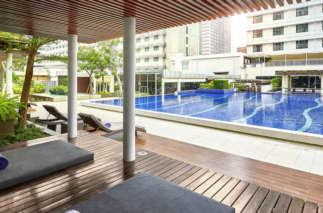 Outdoor pool deck with daybeds at Pullman Jakarta Indonesia Thamrin CBD
