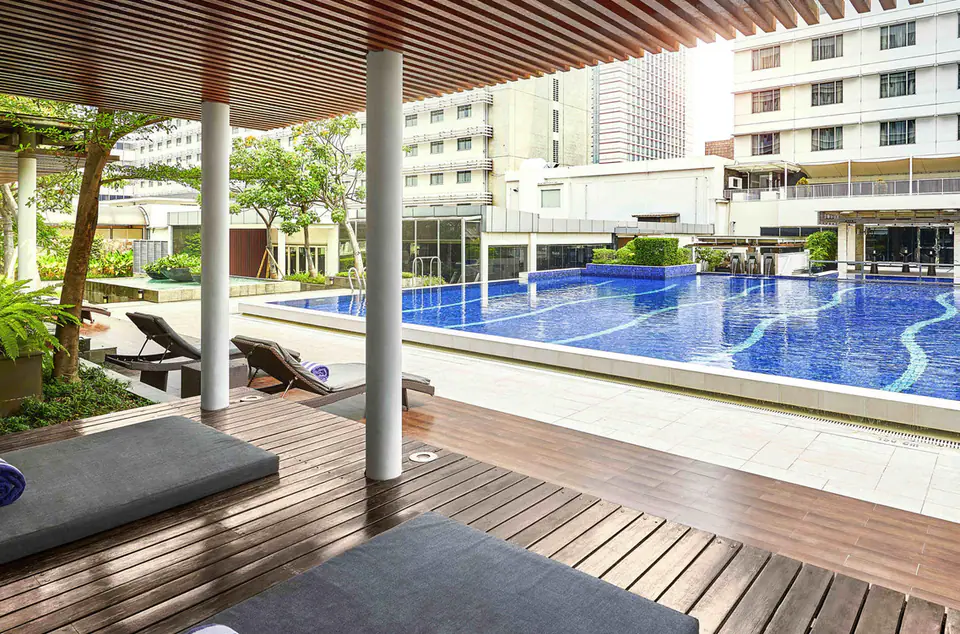 Outdoor pool deck with daybeds at Pullman Jakarta Indonesia Thamrin CBD