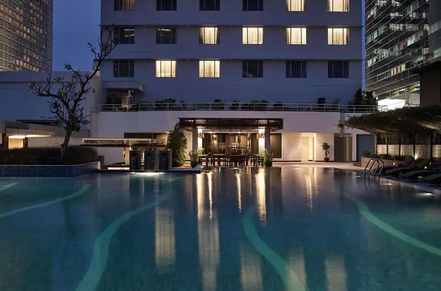Evening view across the pool to the Pullman Jakarta Indonesia facade