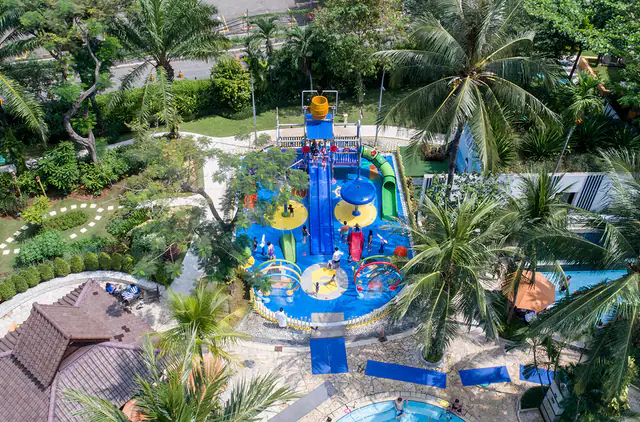 Palm-fringed resort pool in the gardens of Shangri-La Jakarta