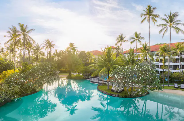 Swimmable lagoon pools winding through the gardens of The Laguna Bali