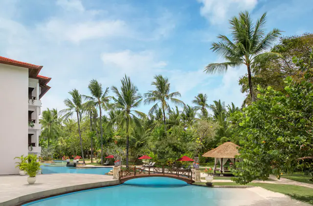 Garden loungers beside a lagoon pool at The Laguna Bali