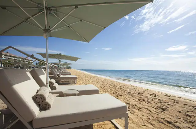 Beachfront loungers on the Nusa Dua sand at The Mulia Bali