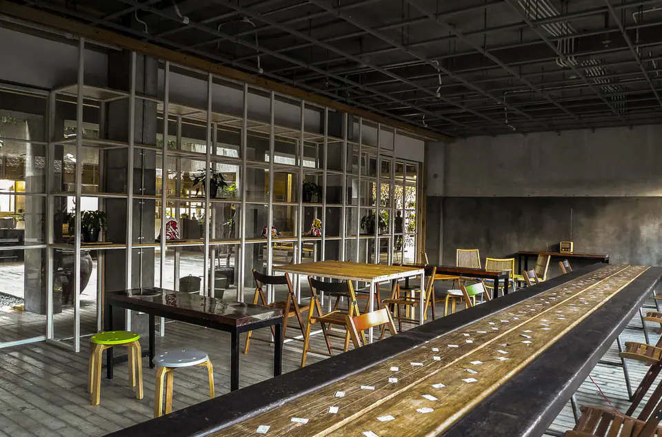 Plant-lined cafe and co-working space at Greenhost Boutique Hotel Prawirotaman