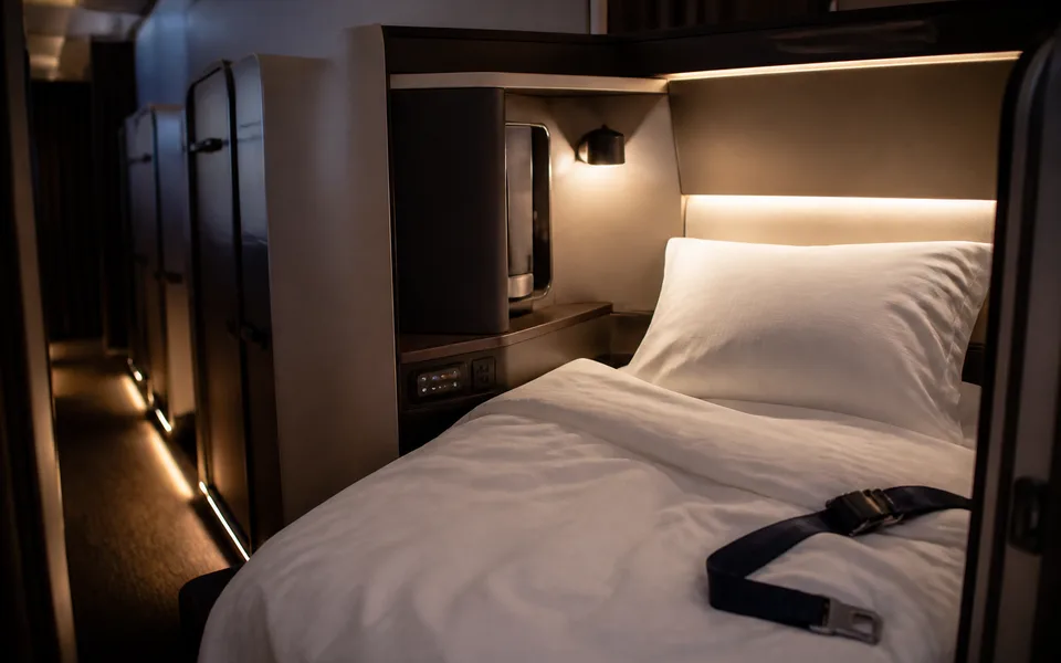 Lie-flat business class suite with soft cabin lighting — best business class airlines ranking (AI-generated illustration)